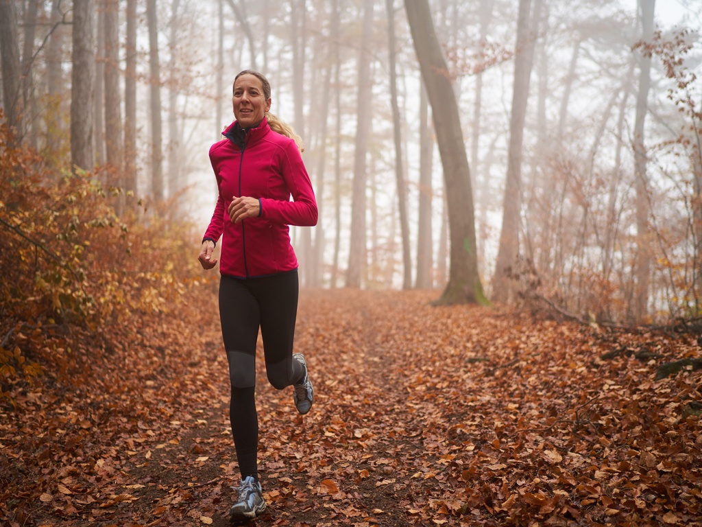 Woman running in woods