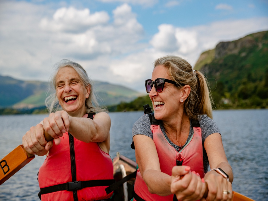 Women in a canoe exercising and having fun